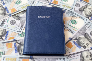Blue passport against the background of money. The concept of travel and business