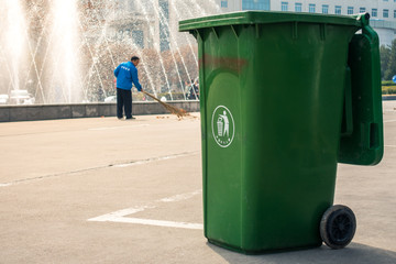 Chinese Trash Can Man Sweeping Behind Recyling University Campus in Xi'an, China March 2018