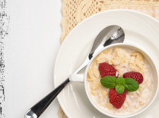 Steel cut oatmeal porridge with raspberry and almond flakes for breakfast