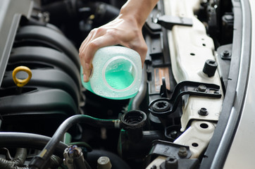 Close up shot hand fill the coolant