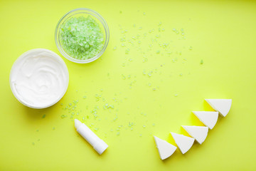 Skin treatment. Cream, soap and other cosmetics on the green background. Top view. Space for your text.
