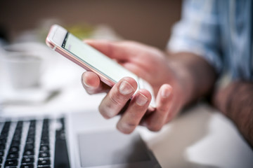 Hand holding smart phone.