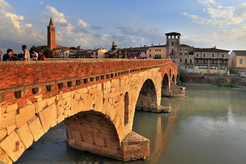 Obraz premium Verona, Italy - Ponte Pietra bridge over Adige river with Verona historic city center panoramic view in the background