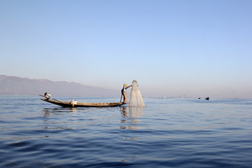 Fisherman with traditional fishing net on Inle Lake, Myanmar (Burma)