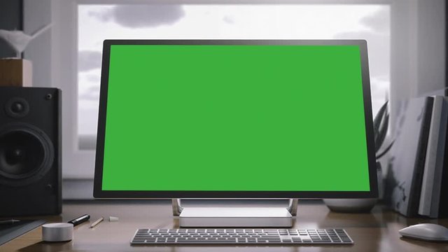     Green Screen Computer.  Computer and keyboard in the office. Green screen footage for image replacement