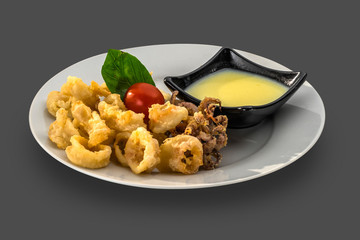 fried squid and octopus garnished with souse and cherry tomatoes