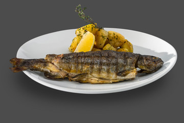 fried trout served whole with roasted potatoes and herbs