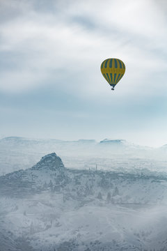 Hot air balloon and Cappadocia aerial view during winter