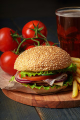 Fast food, homemade burger on a wooden background