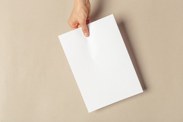 Hand holding papers a4 size