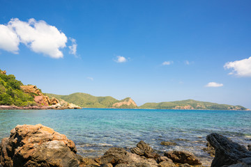 Fototapeta premium Beautiful white clouds on blue sky over calm sea with sunlight reflection