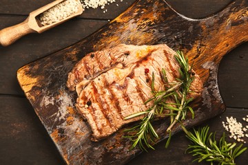 Grilled steak on wooden cutting board