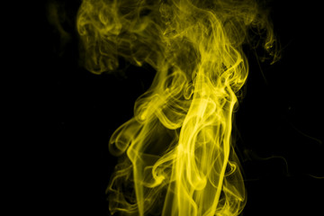 Yellow smoke on black background