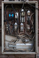 Old electric breaker box with wires and fuses