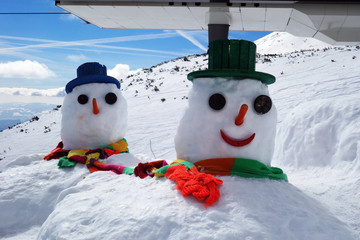 A high mountain snowman delivers joy with a smile