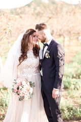 Happy newlyweds posing outdoors. Wedding day.