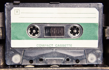 A spinning cassette tape in a player, the surface is badly scratched.