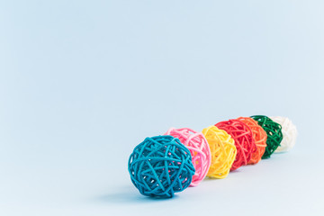 Multicolored rattan balls isolated on blue background