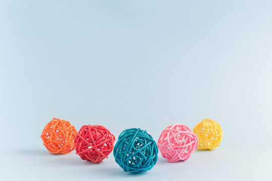Multicolored rattan balls isolated on blue background