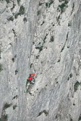 man rock climber climbs on the cliff