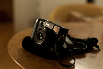 Fototapeta na wymiar cool black vintage photo camera on wooden table