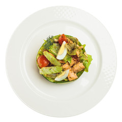 Smoked salmon salad isolated on white background. Salmon, eggs, lettuce and tomatoes on white plate, top view