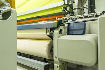 weaving loom at a textile factory, closeup. industrial fabric production line