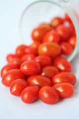 Small red tomatoes on white background