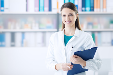 Smiling female doctor holding a clipboard