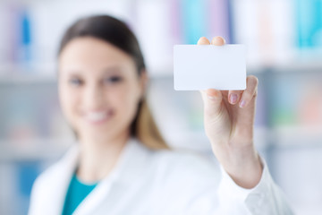 Female doctor holding a business card