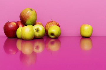 Ripe apples on the pink or magenta background. Concept of healthy food