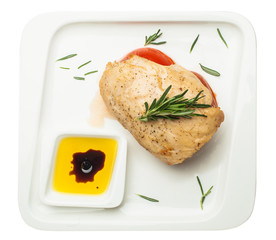 Healthy Eating. Chicken breast with tomato and rosemary on white plate isolated on white background, top view