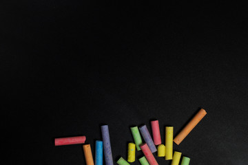 Colored crayons on a blackboard.