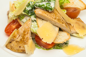 Chicken Salad Closeup. Chicken Caesar Salad. Caesar Salad with grilled chicken. Grilled chicken breasts and fresh salad in plate