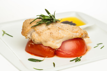 Roasted chicken breast with tomato and rosemary herb closeup
