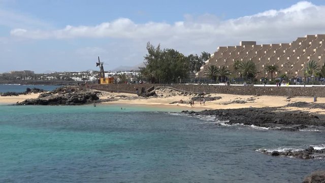 Tourists sunbathing on the Playa del Jablillo beach in Costa Teguise Lanzarote Spain