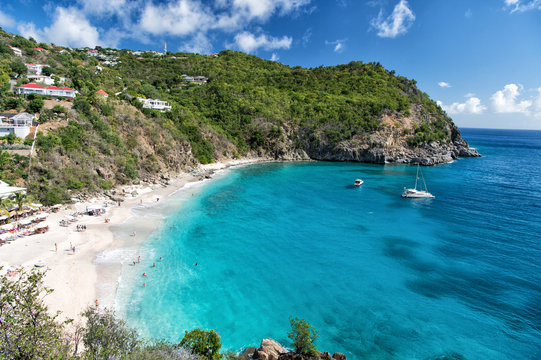 Fototapeta Harbor with sand beach, blue sea and mountain landscape in gustavia, st.barts. Summer vacation on tropical beach. Recreation, leisure and relax concept. Wanderlust and travel with adventure.