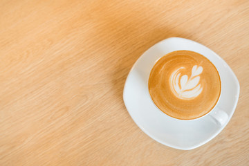 Heart drawing on cappuccino art coffee cup with copy space