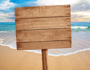wood sign on beach background