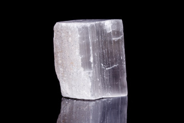 Macro mineral stone Selenite on black background