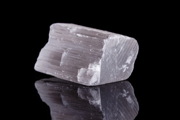 Macro mineral stone Selenite on black background