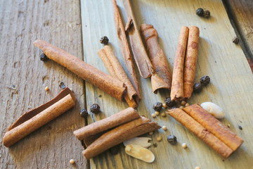 Cinnamon sticks, rolls on wooden backround.