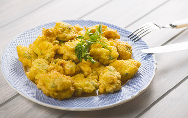 Cod fritters with cutlery. Spanish food.