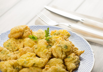 Cod fritters with cutlery. Spanish food.