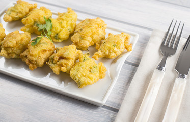 Cod fritters with cutlery. Spanish food.