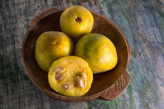 rare araza fruits in a wooden bowl on rustic background