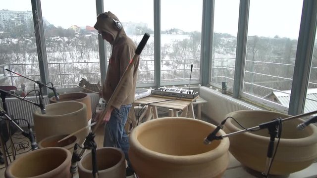 A keen man plays concept music on clay pots