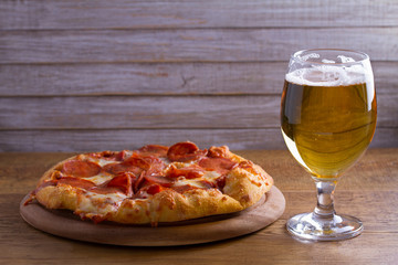 Beer and pizza. Glass of beer. Ale and appetizer snack.