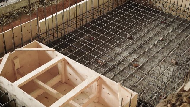 top view of the process of the formwork of space, builders are engaged in the construction of a structure of reinforced concrete