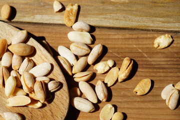 Pine kernel nuts, pinons on wooden surface.